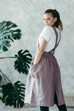 Linen pinafore apron worn by a maker