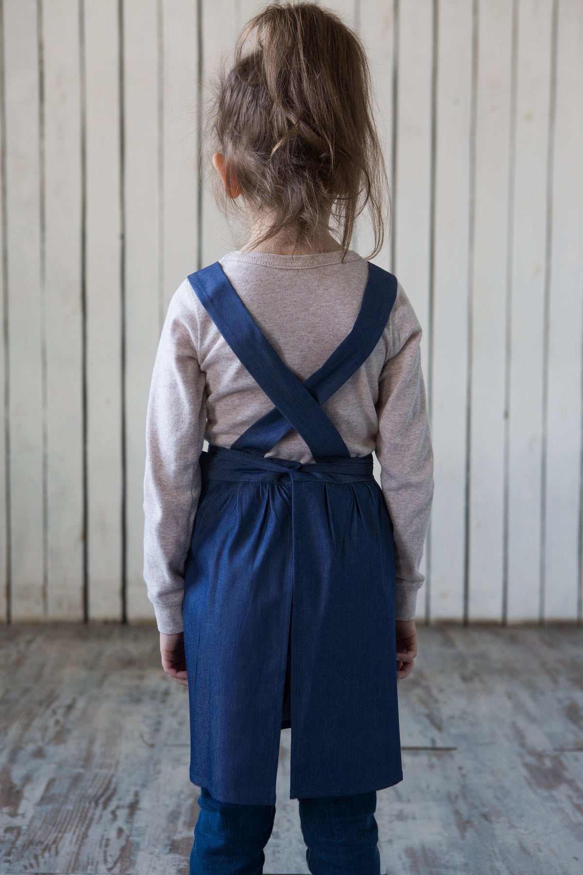 Denim cross back apron, back view