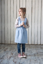 Kids linen cross back apron, styled