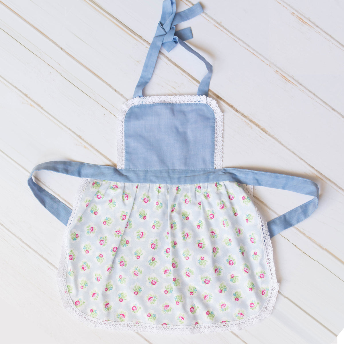 Maggie Blue toddler apron in printed cotton with lace trim