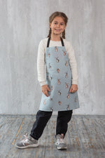 Bunny print apron worn by a child in the kitchen