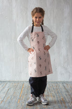 Bunny print apron on a child while baking