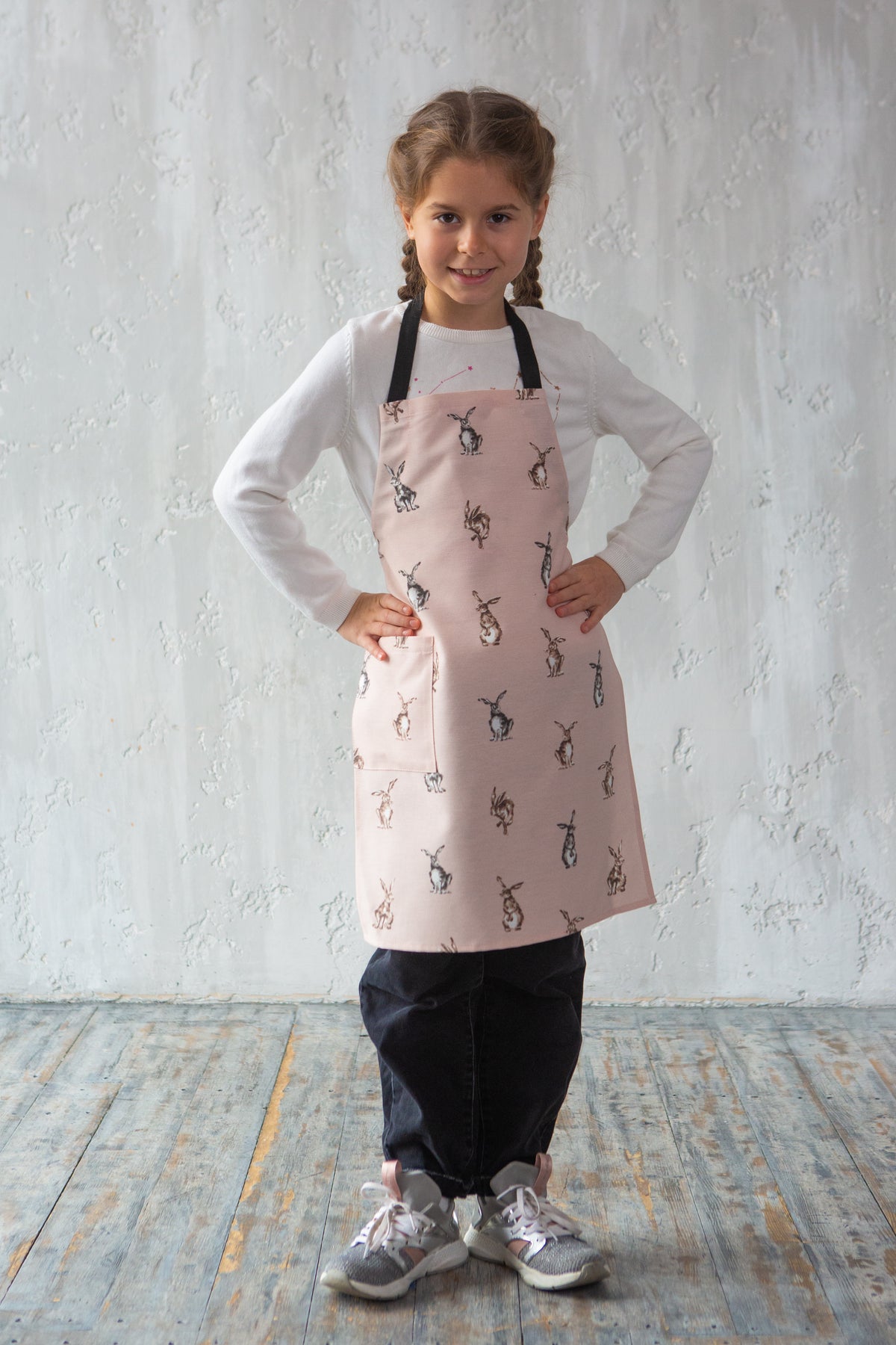 Bunny print apron on a child while baking