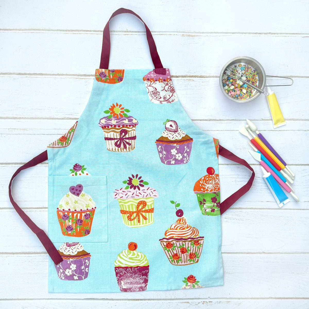 Blue and pink cupcake print cotton apron, front view