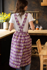 Pinafore apron with pockets, worn by a woman