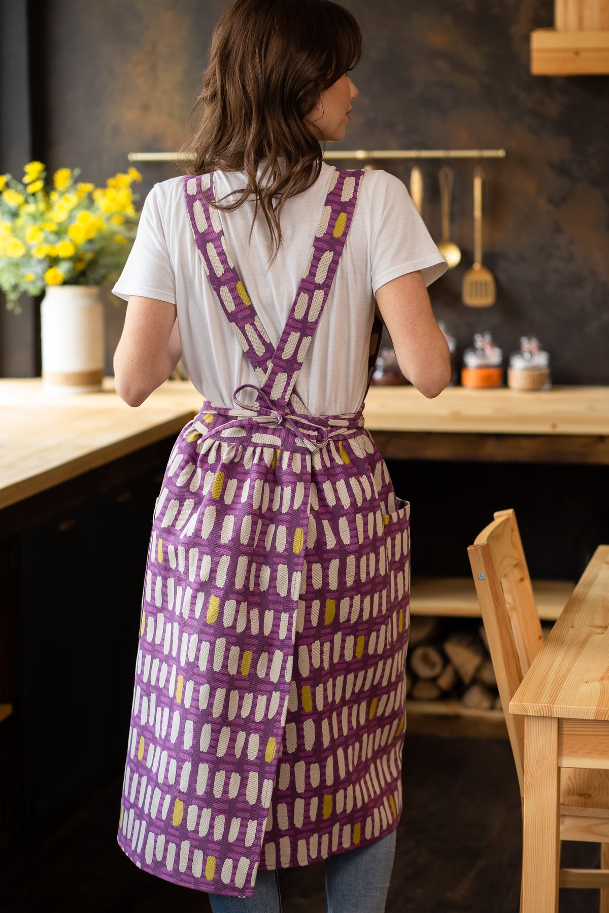 Pinafore apron with pockets, worn by a woman