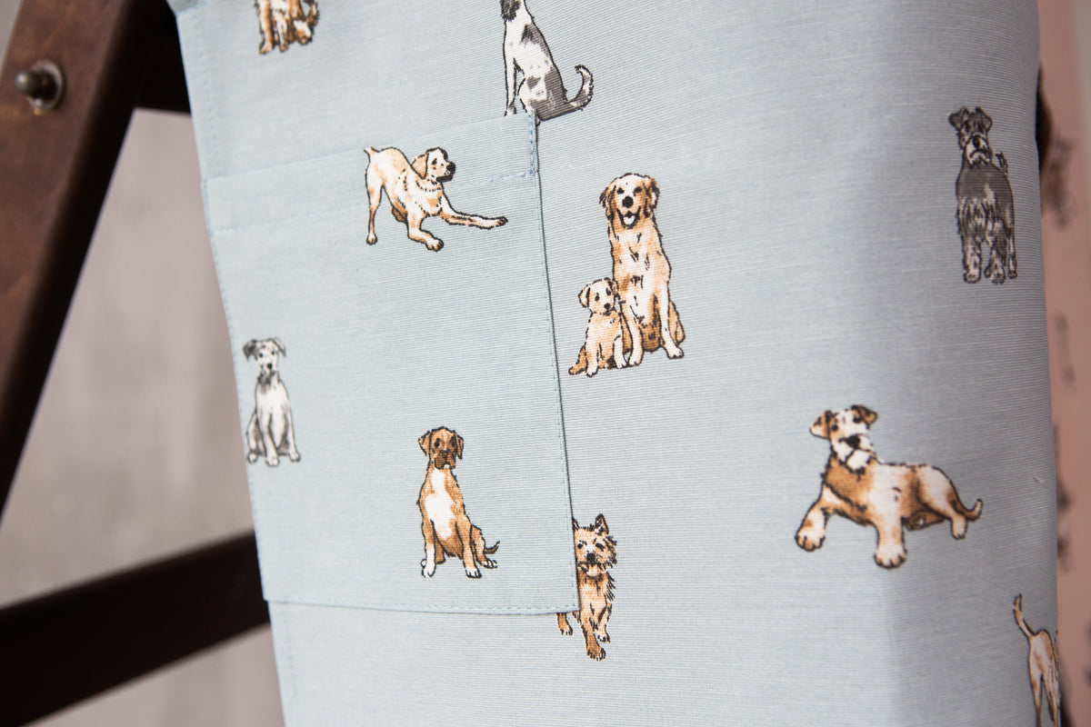 Dog print kids apron, pocket and print detail