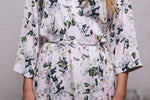 Floral satin robes worn by the bride and bridesmaids