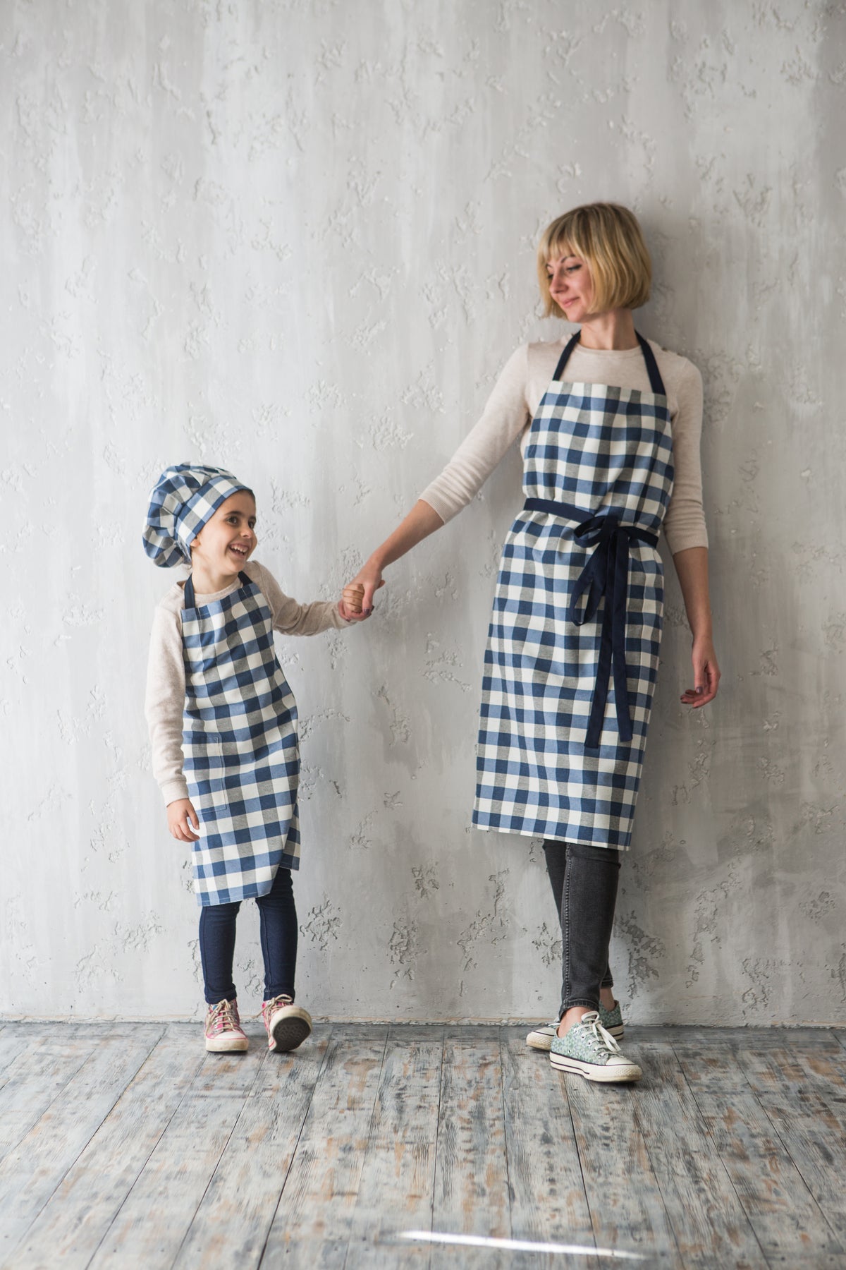Matching gingham check aprons for mother and child