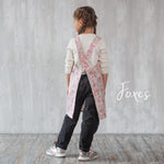 Cross back straps on the kids pinafore apron