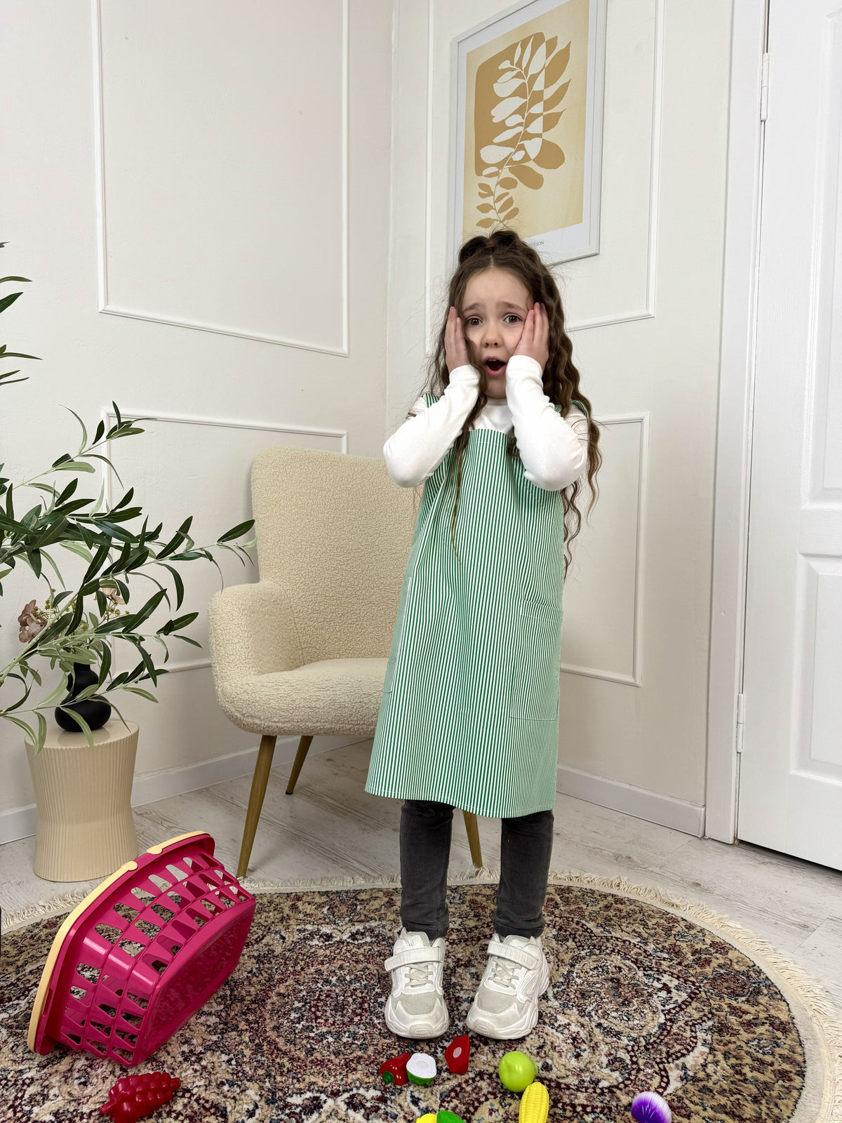 Kids cross back smock apron in green stripe, worn