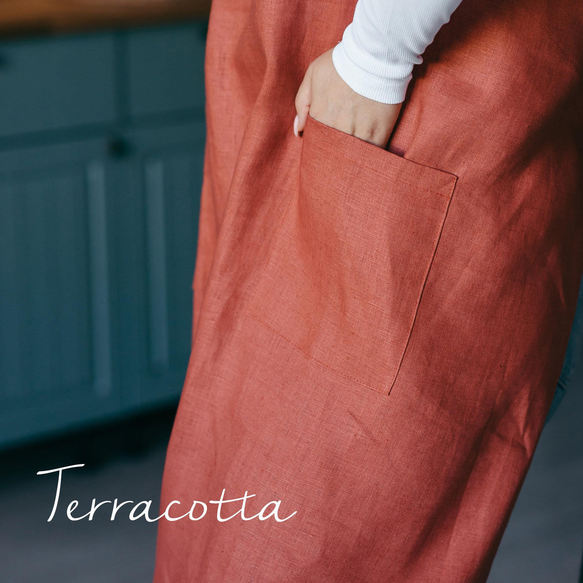 Linen split leg apron styled on a model, teal