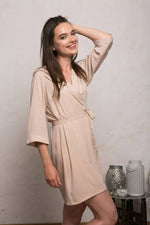 Close view of the stretchy crepe fabric in warm nude