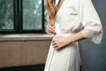Chantilly lace detail at the collar of the ivory satin robe