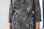 Short floral kimono robe folded, showing the satin finish