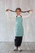 Unisex kids apron styled on a child in the kitchen