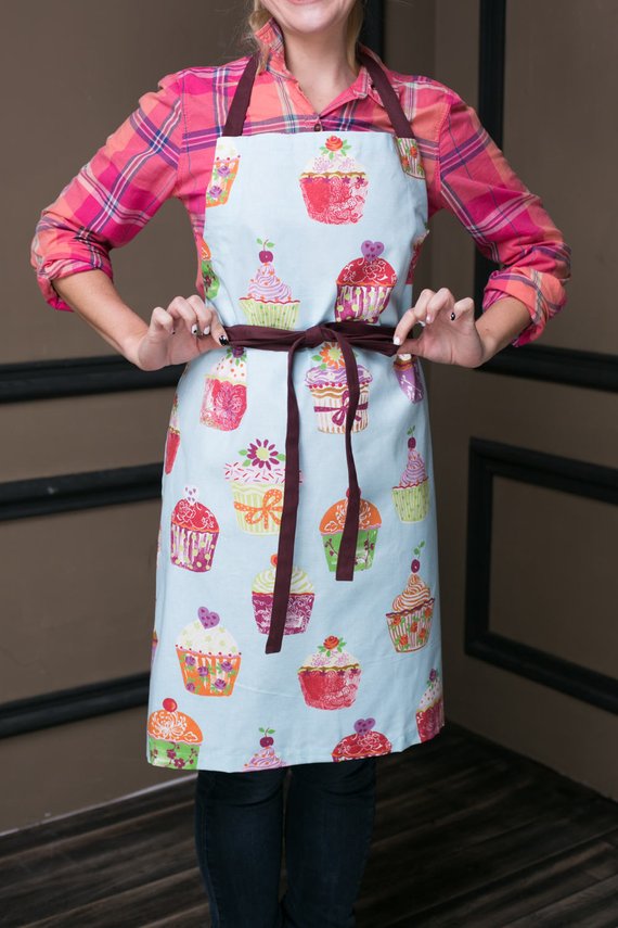 Blue cupcake print kids apron, flat lay