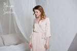 Satin robe close-up, beige fabric sheen