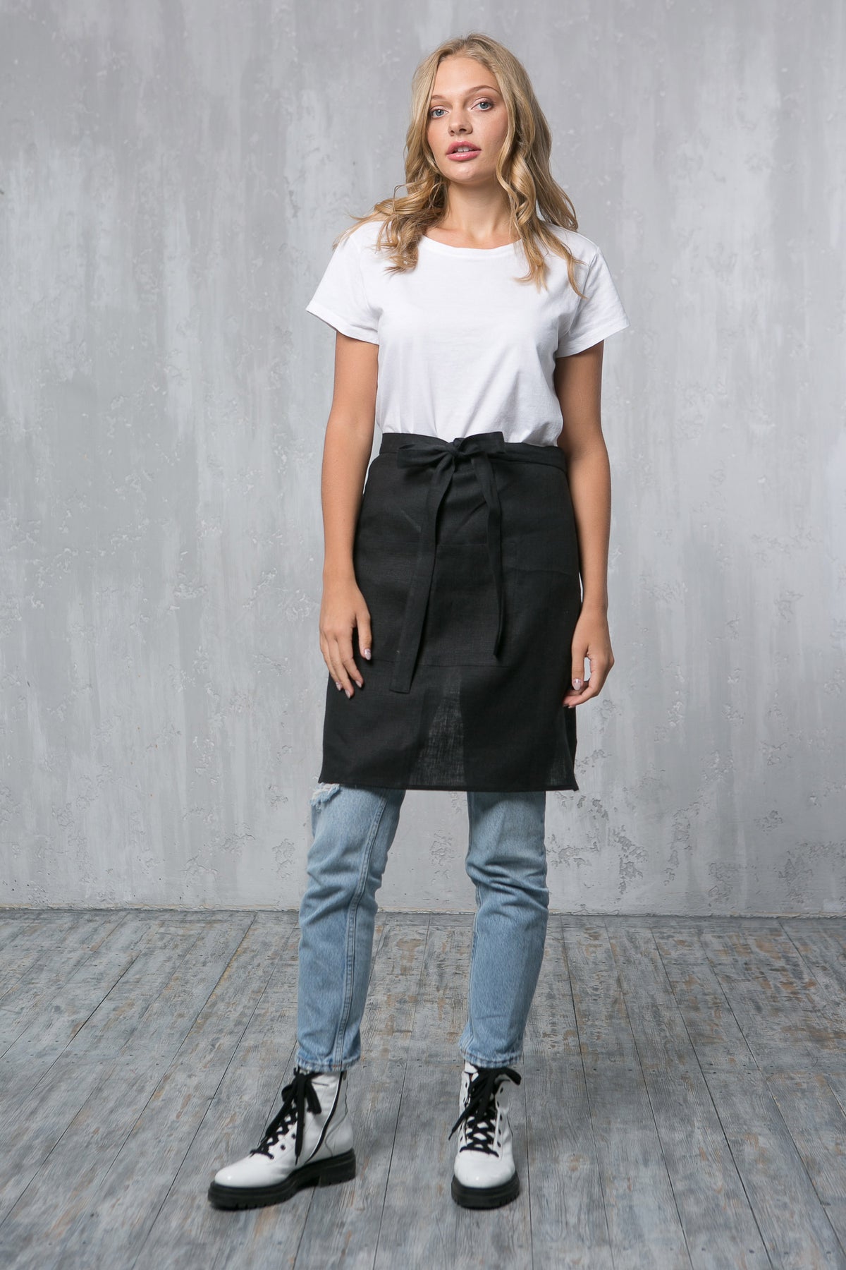 Black linen waist apron with pockets, front view