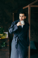 Hooded linen robe in black, worn open