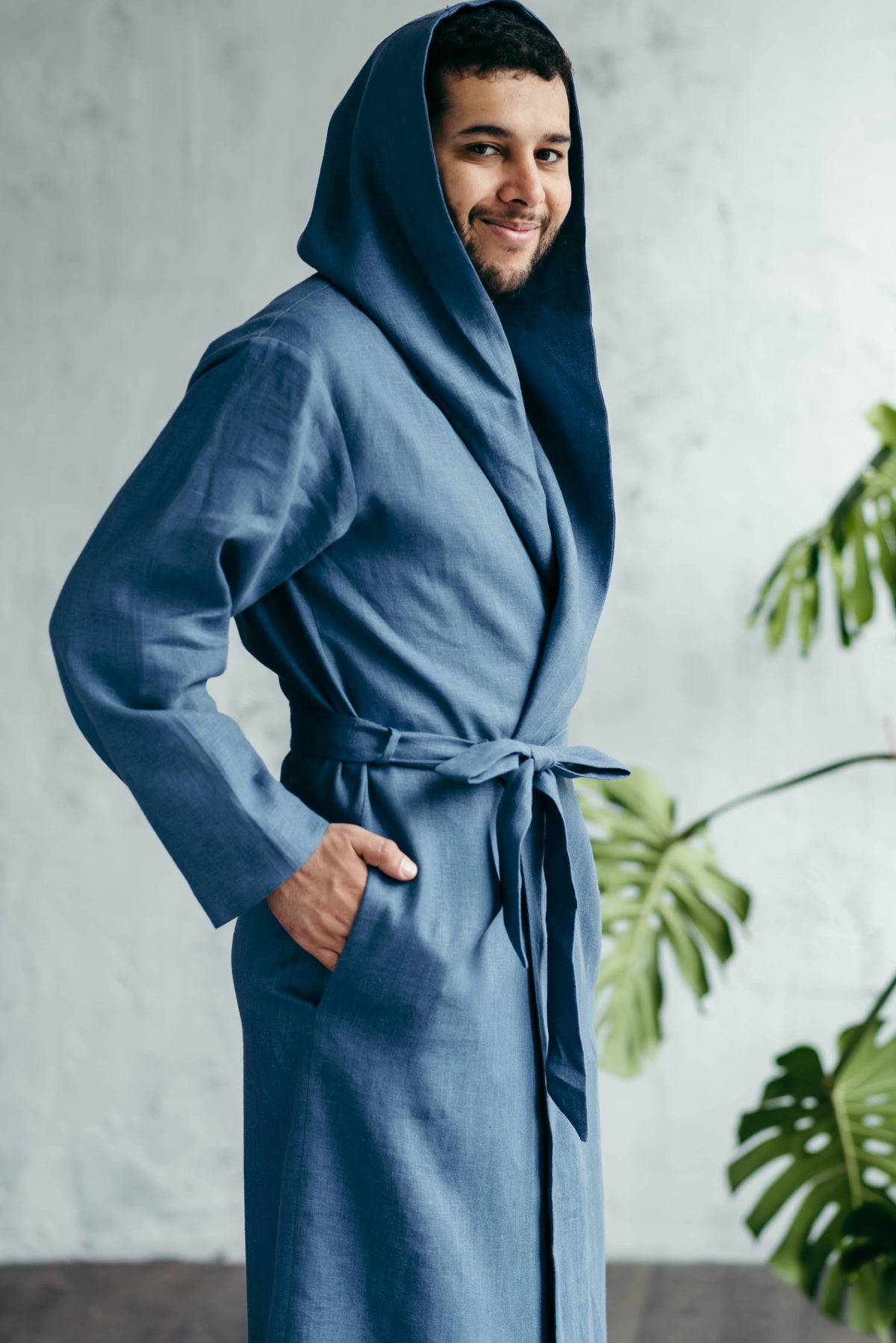 Man wearing a hooded linen dressing gown, hood up