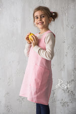 Kids cross back linen apron, styled